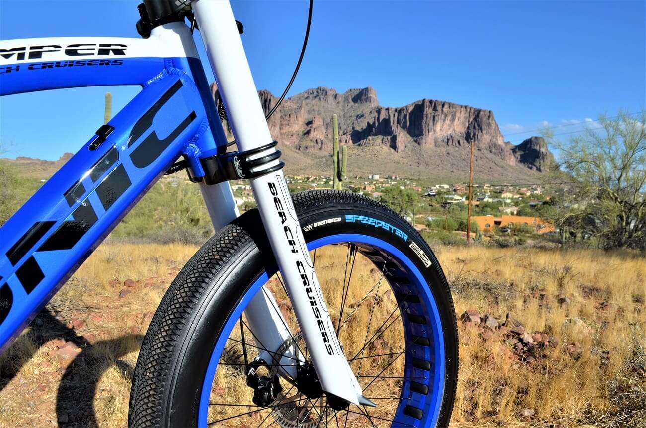 Blue bicycle with mountains in the background.