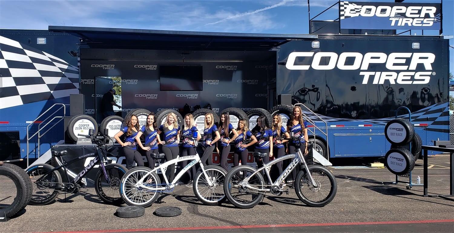 Cooper Tires display with bicycles and staff.
