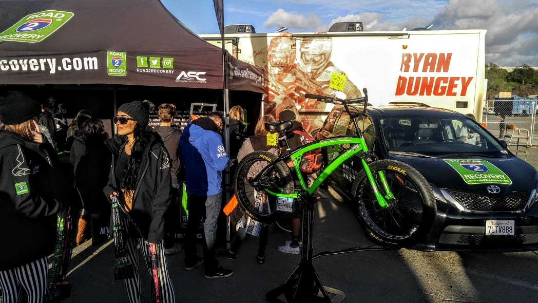 Outdoor event with green bicycle display.