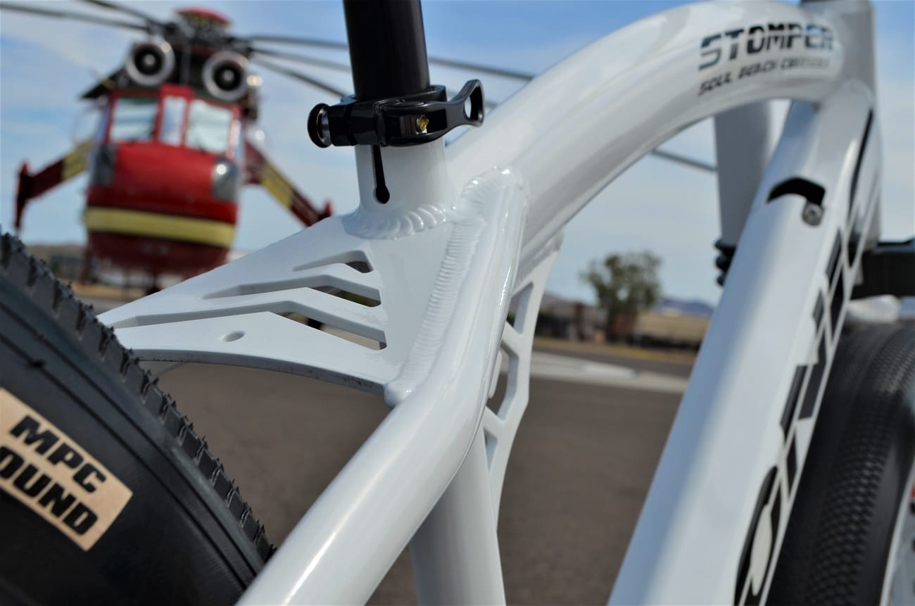 Bicycle frame with helicopter in background.