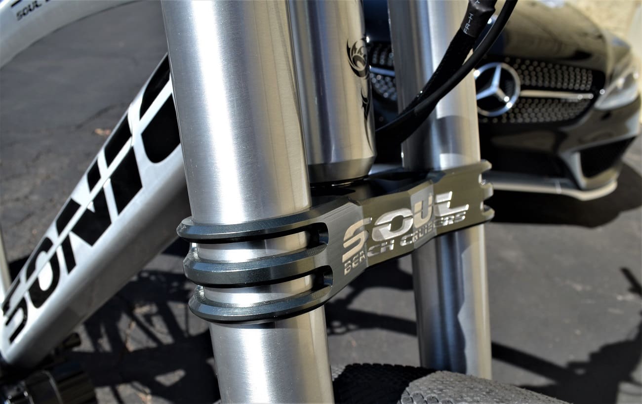 Bicycle frame close-up with car background.