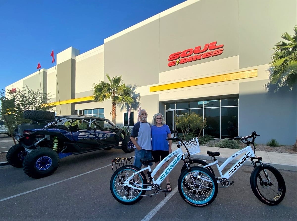 Couple with electric bikes outside Soul Bikes.