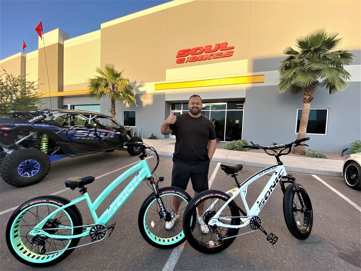 Man with bicycles outside Soul Beach Cruisers.