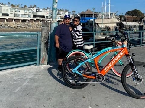 Couple with bicycles on a pier.