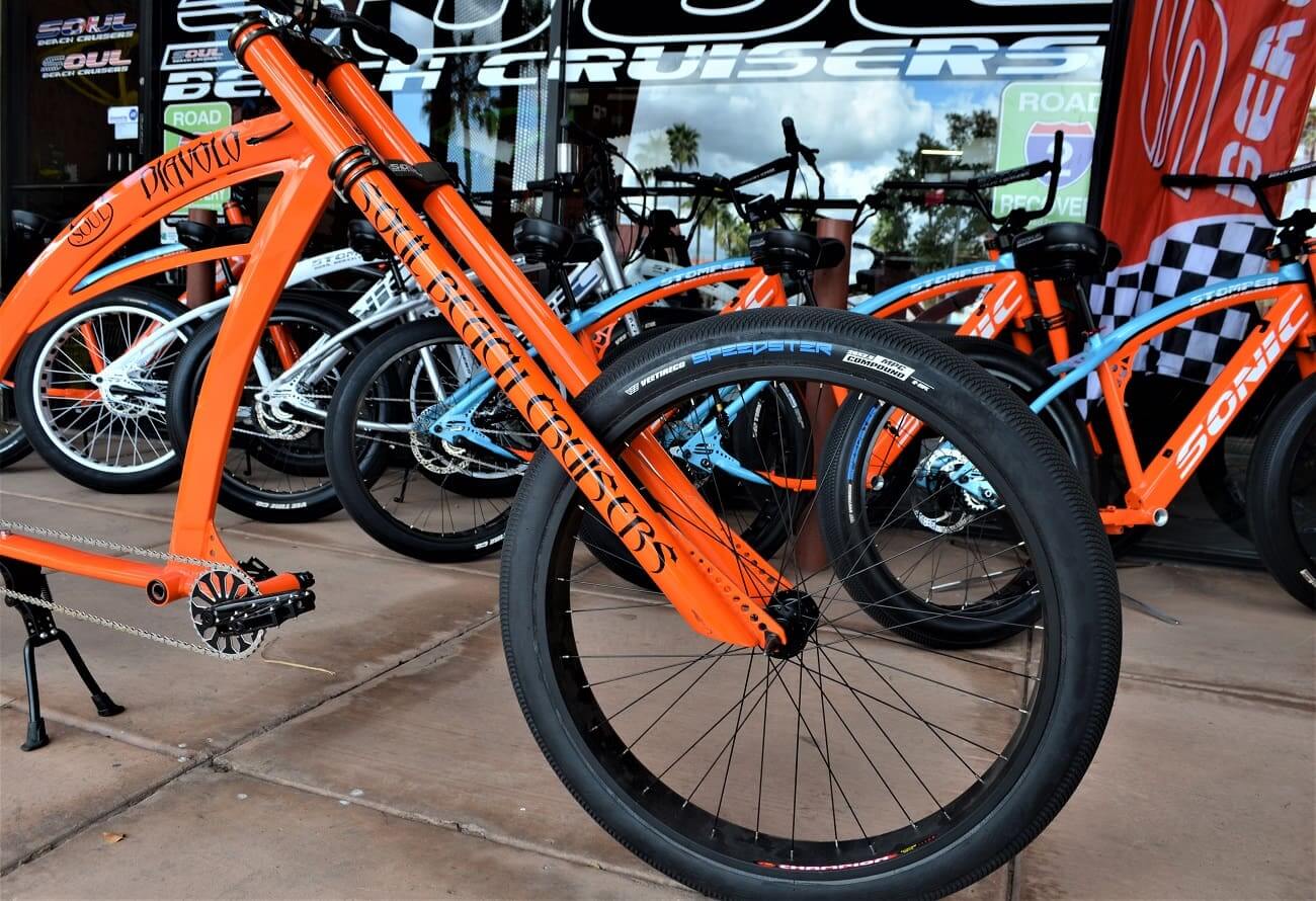 Orange and blue beach cruiser bicycles displayed.