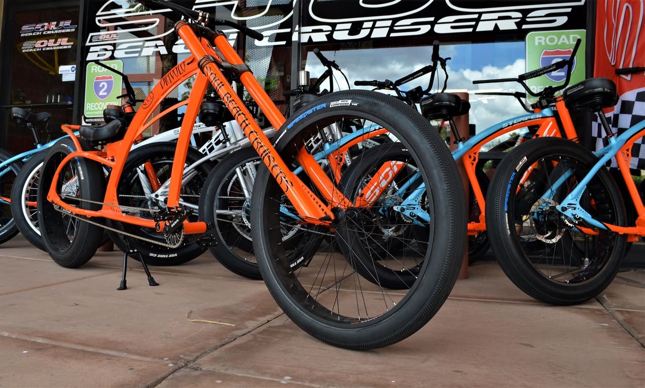 Orange and blue cruiser bikes on display.