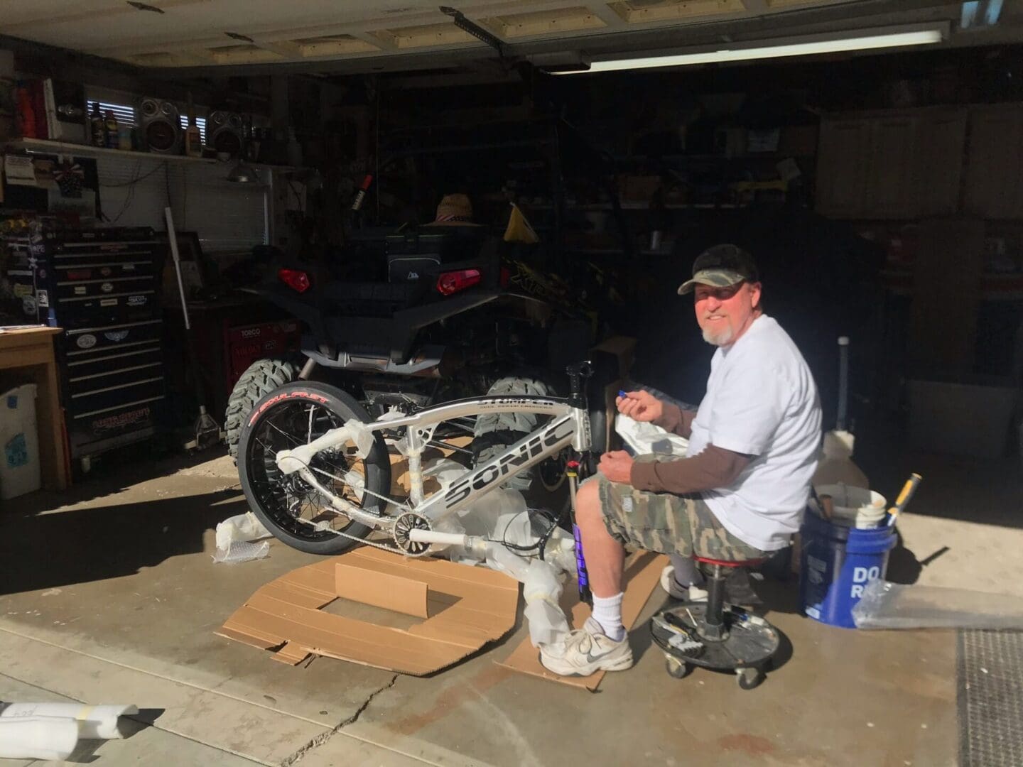 Man working on bike in garage.