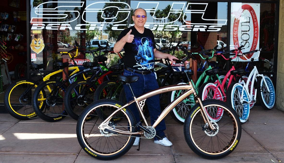 Man giving thumbs up with bicycle.