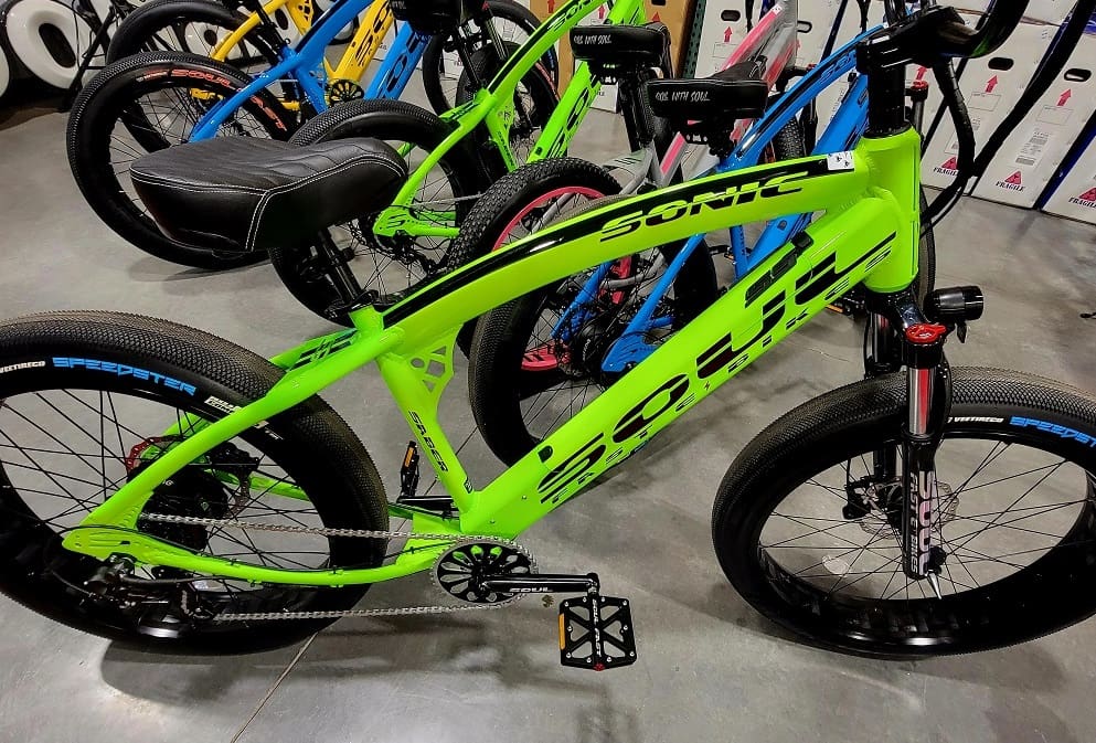 Bright green electric bike with black tires.