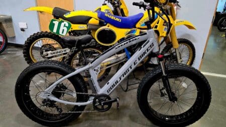 Electric bike and two yellow dirt bikes.