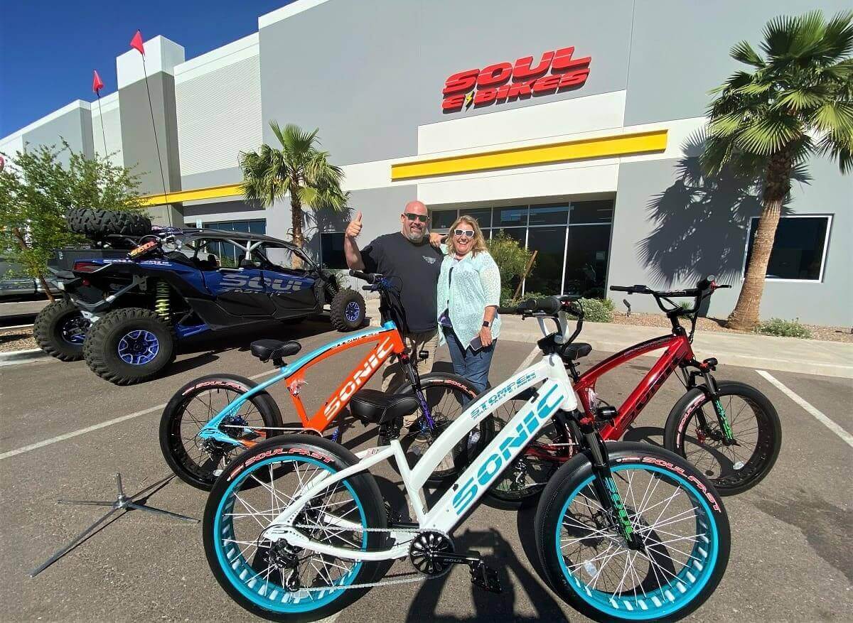 People with electric bikes outside Soul E Bikes.