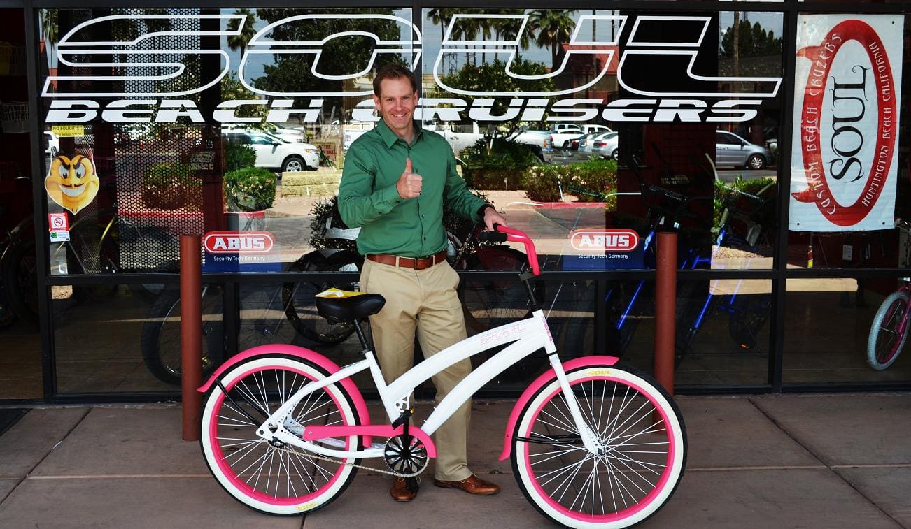 Man with bicycle at Soul Beach Cruisers.