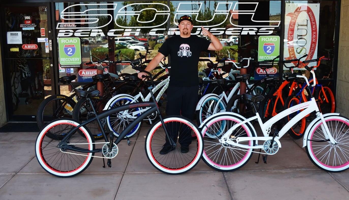 Man with bicycles outside Soul Beach Cruisers.