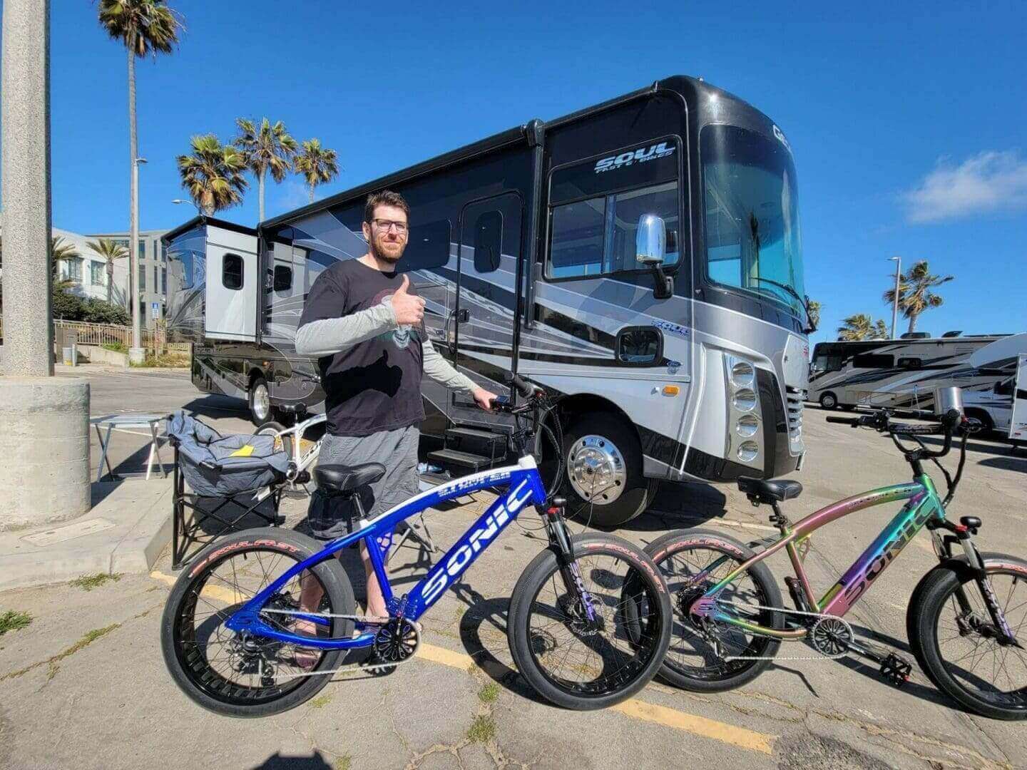 Man with bikes in front of RV.