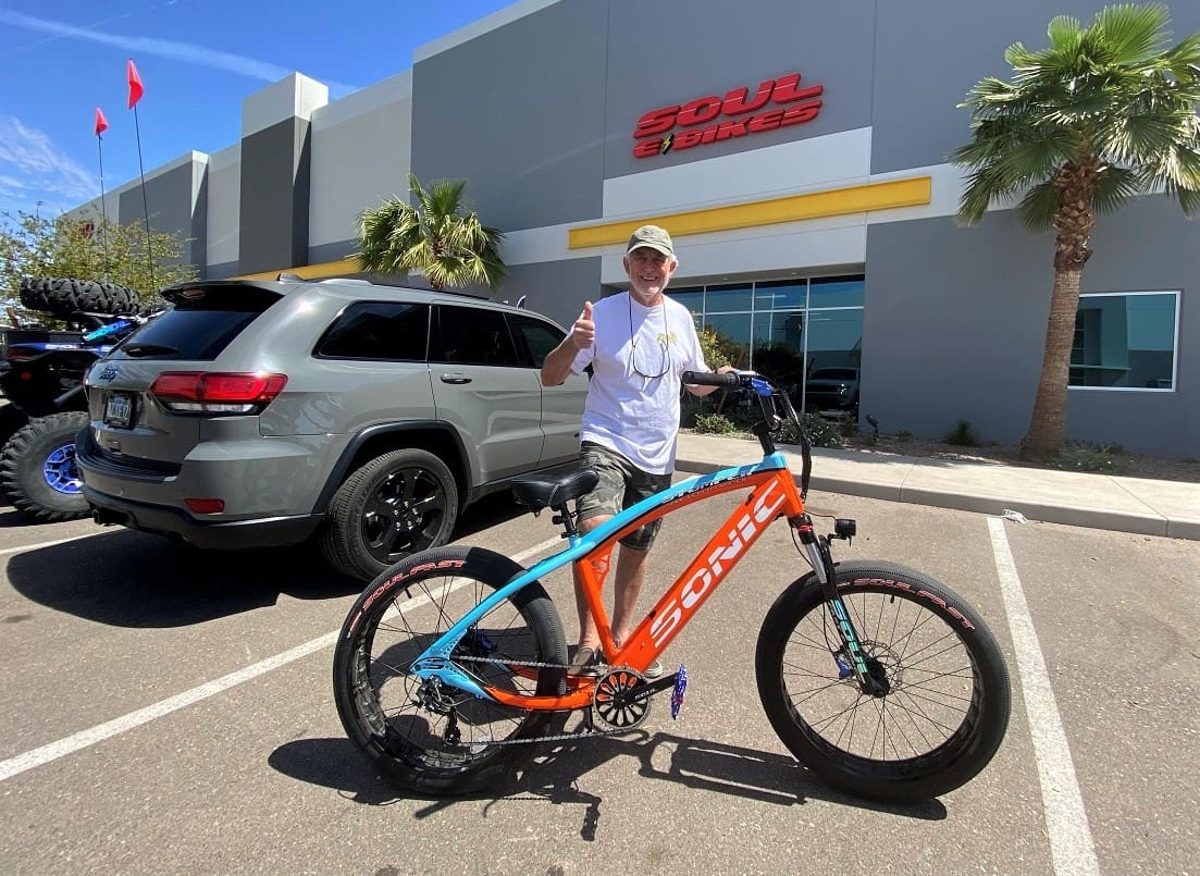 Man with bike outside Soul Bikes store.