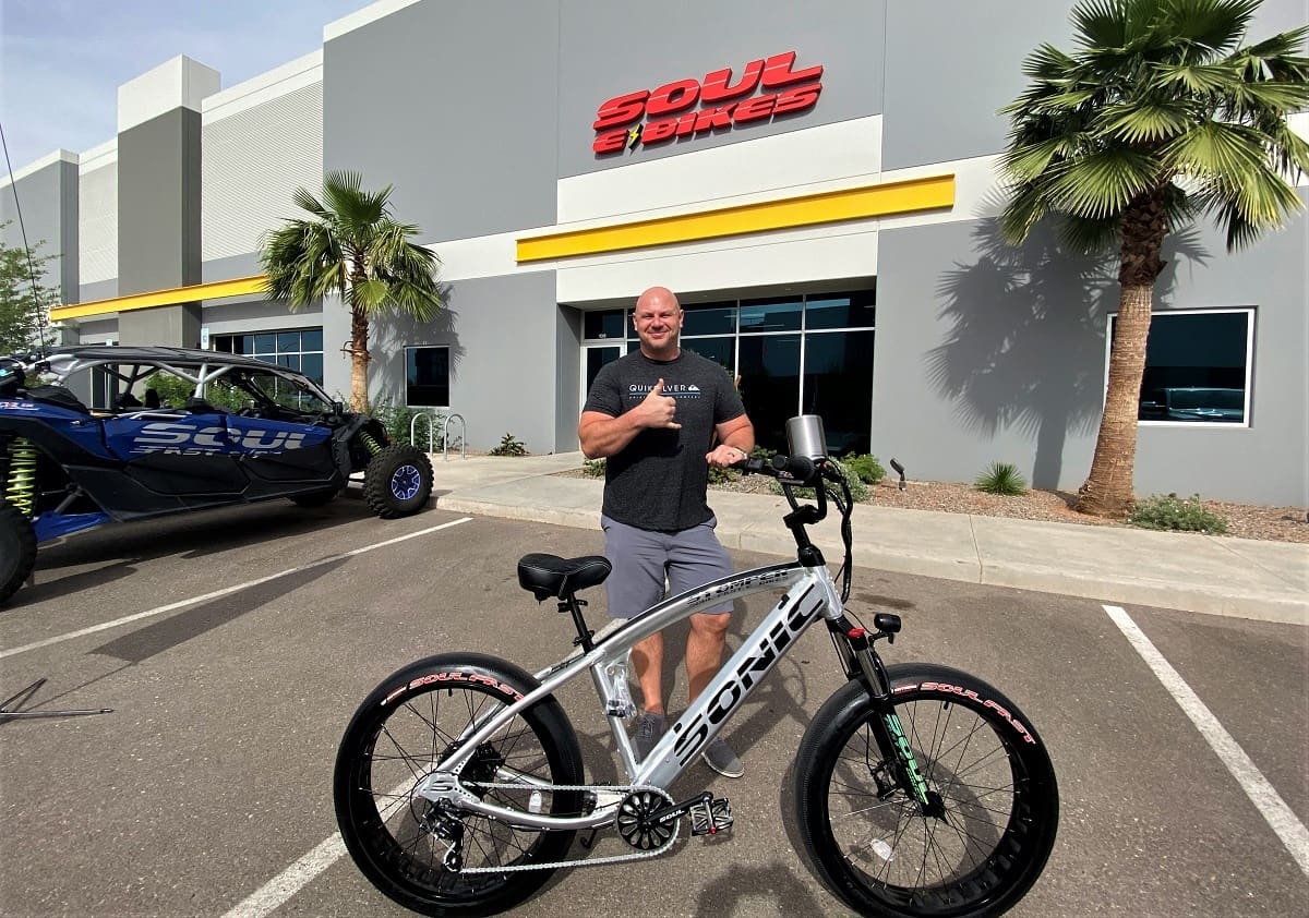 Man posing with bicycle outside Soul Bikes.