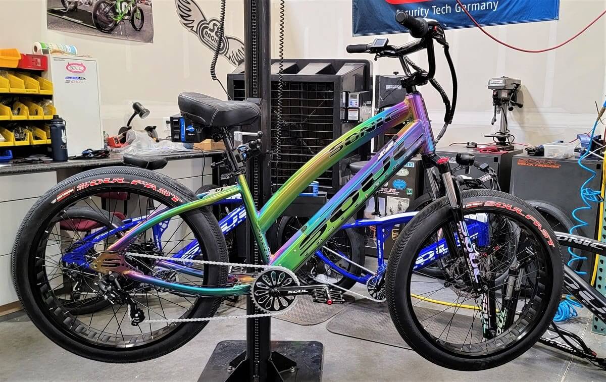 Colorful bicycle on a repair stand indoors.