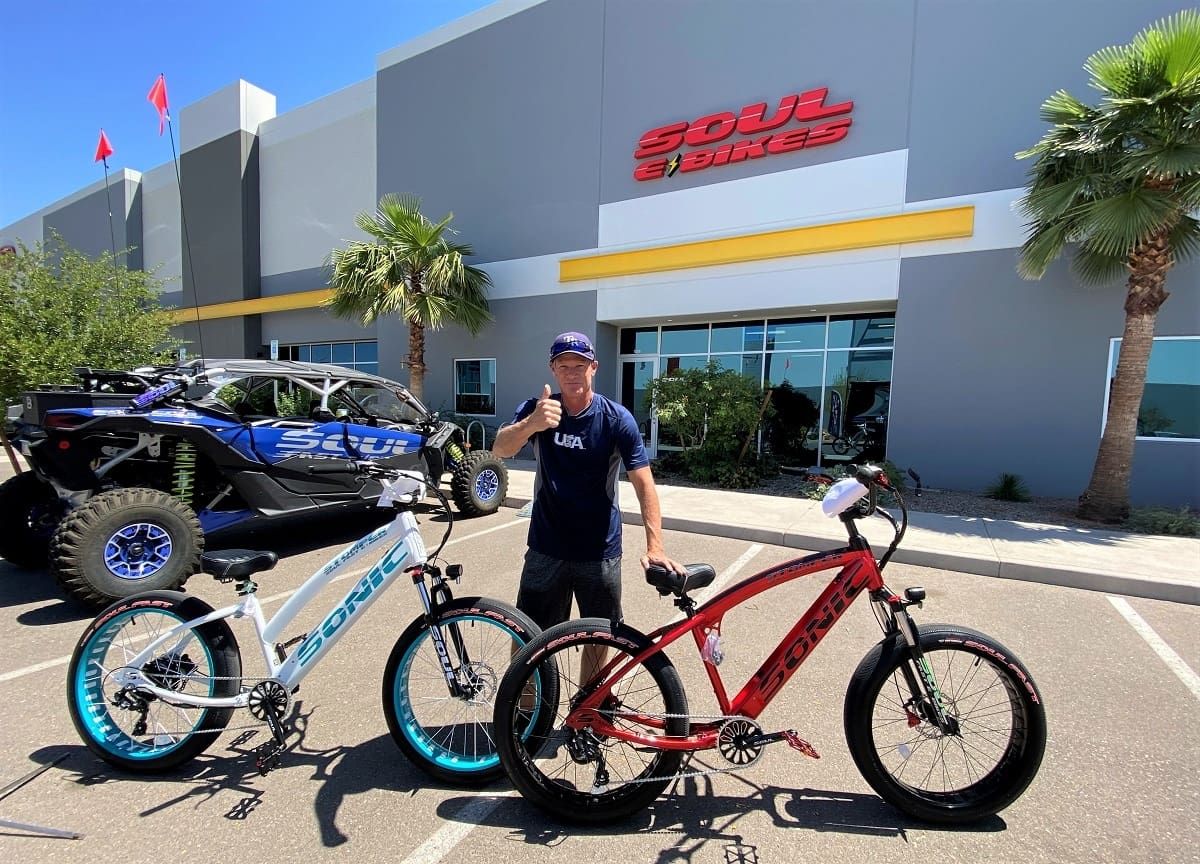 Person with e-bikes outside Soul E Bikes.