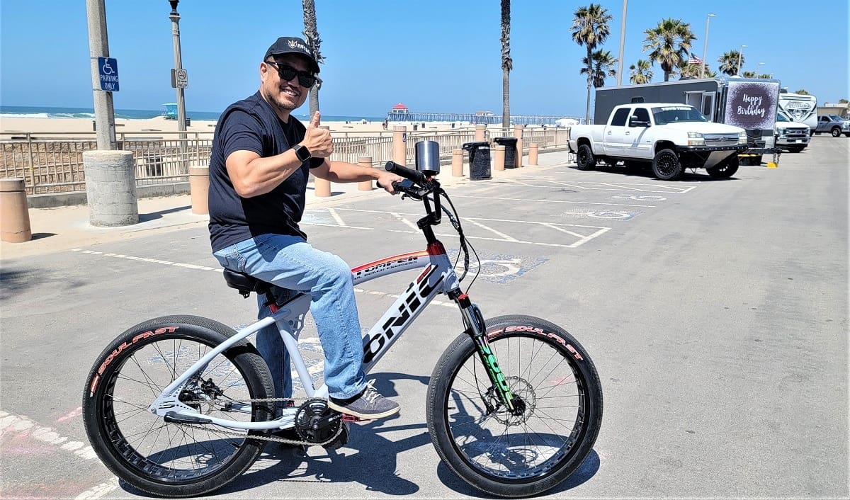 Man riding bike near the beach.