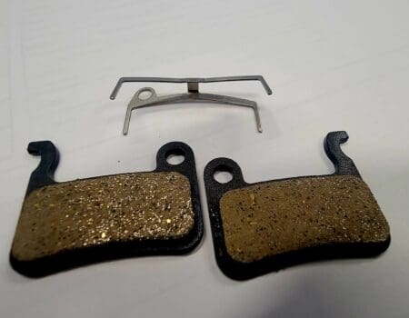 Bicycle disc brake pads and spring clip.