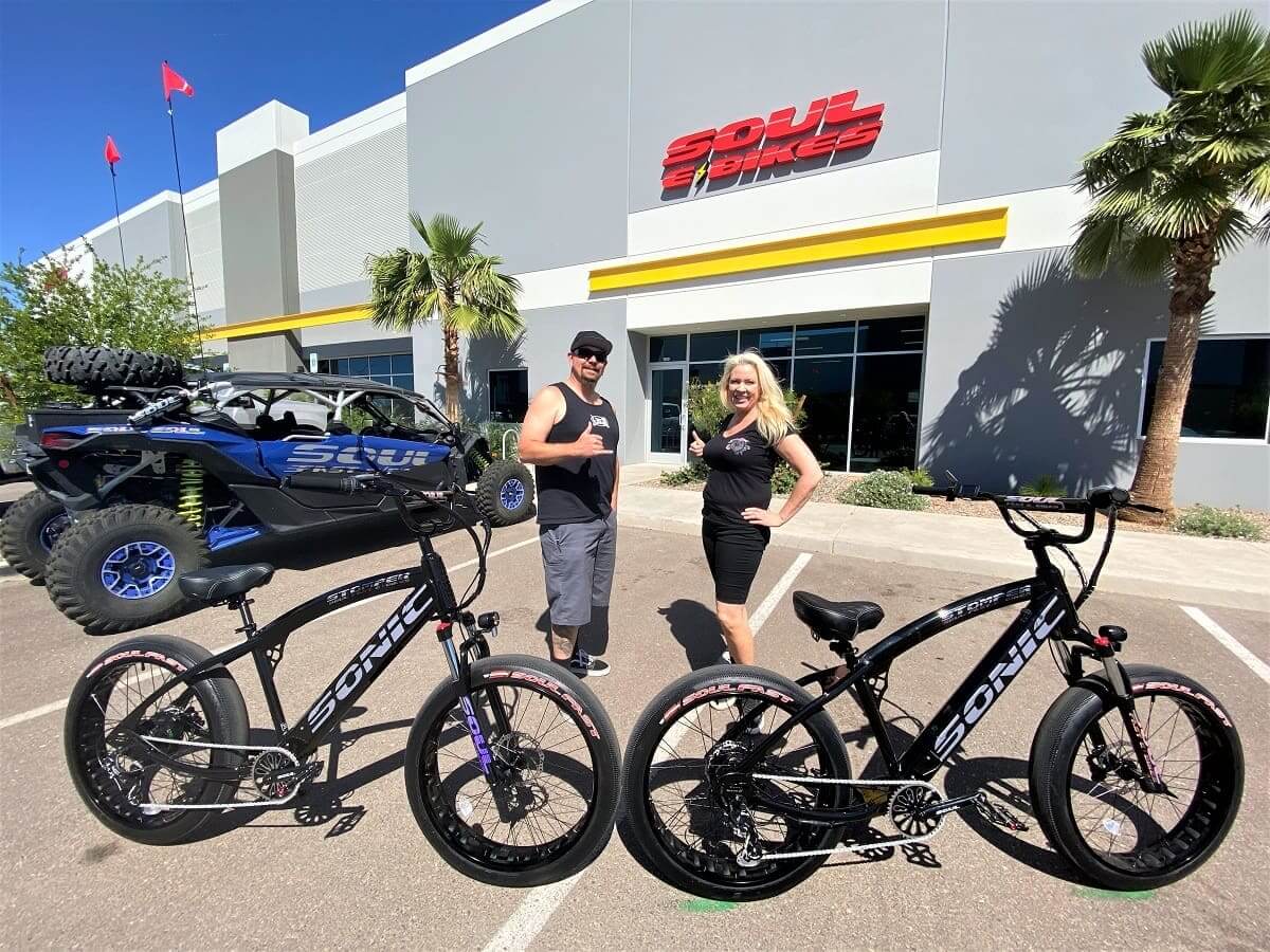 People posing with bicycles outside Soul Bikes.