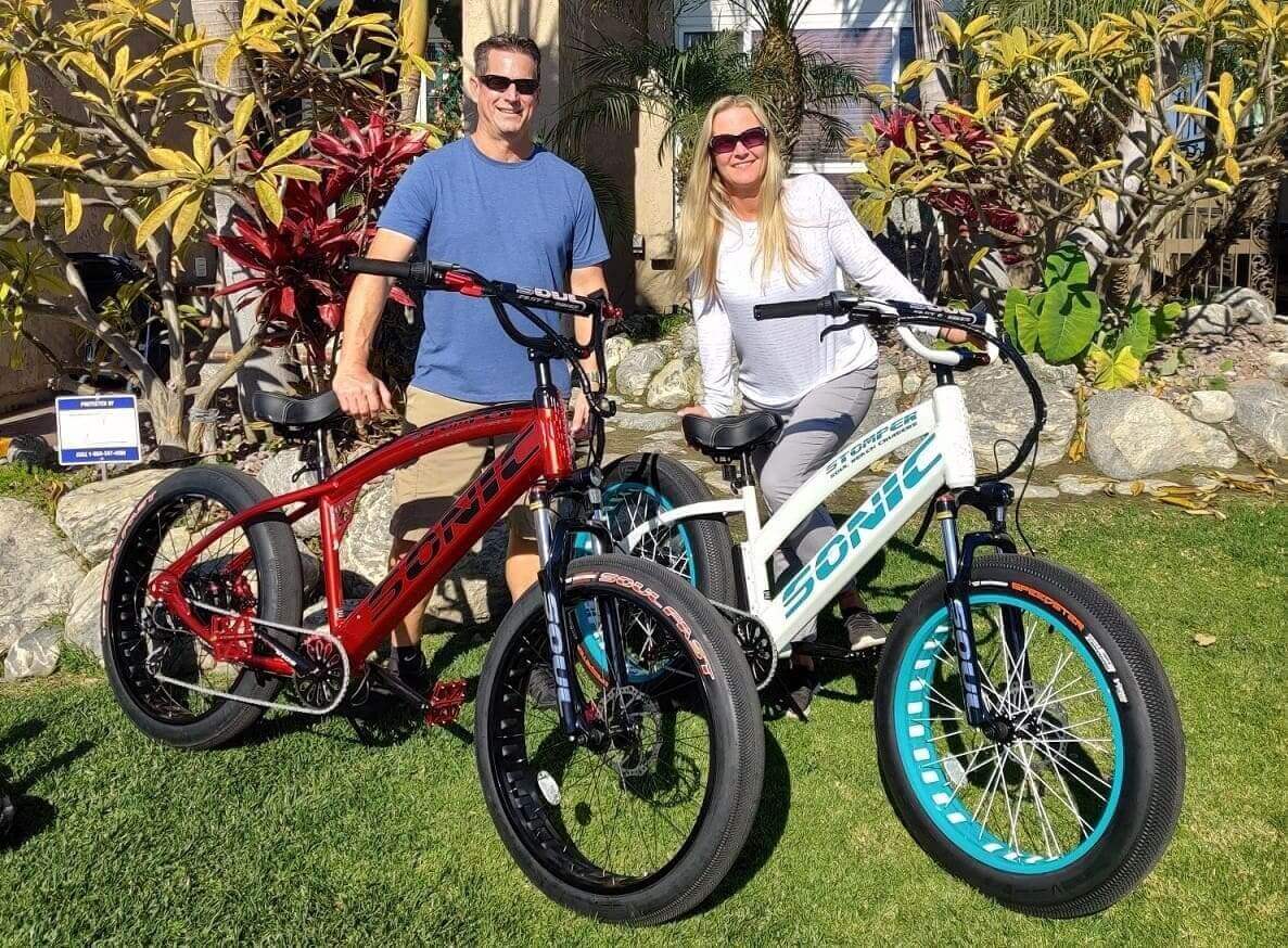 Two people with colorful electric bicycles.