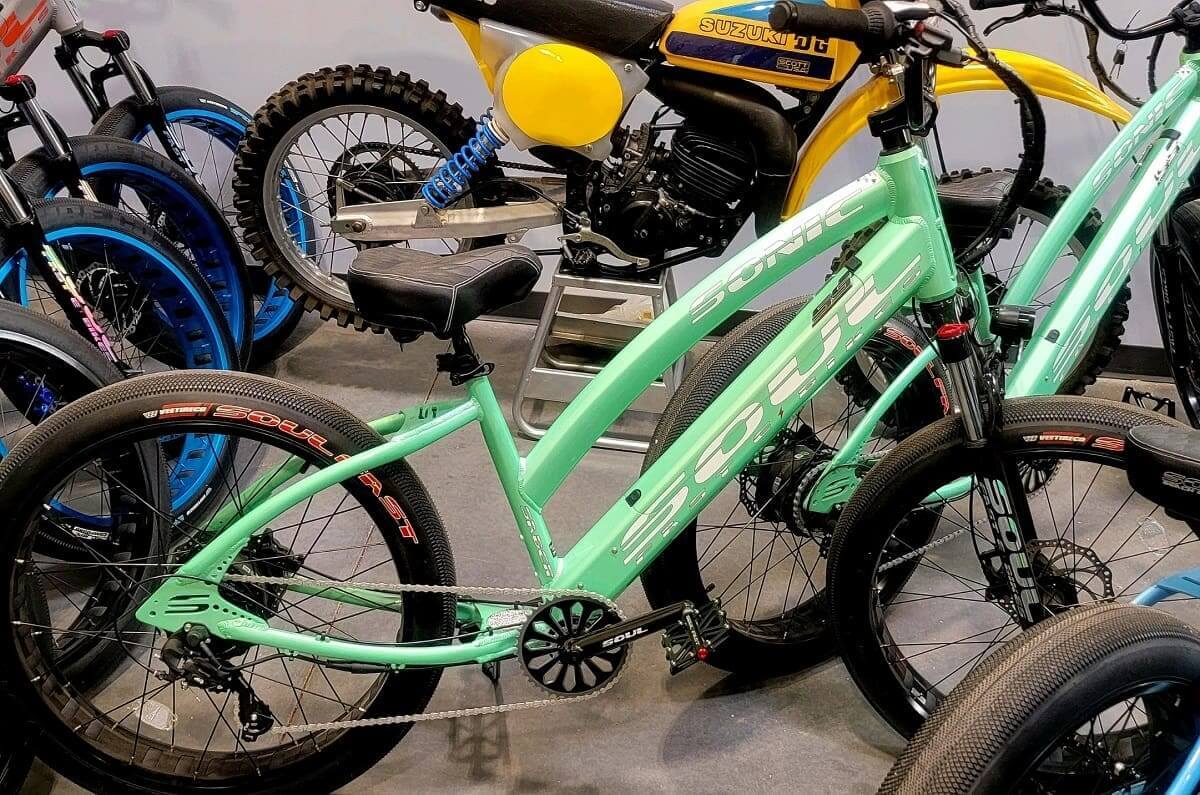 Mint green bicycle among other bikes displayed.