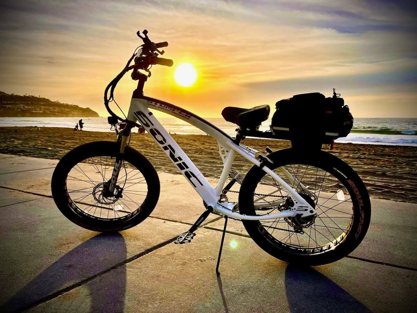 Electric bicycle by the beach at sunset.
