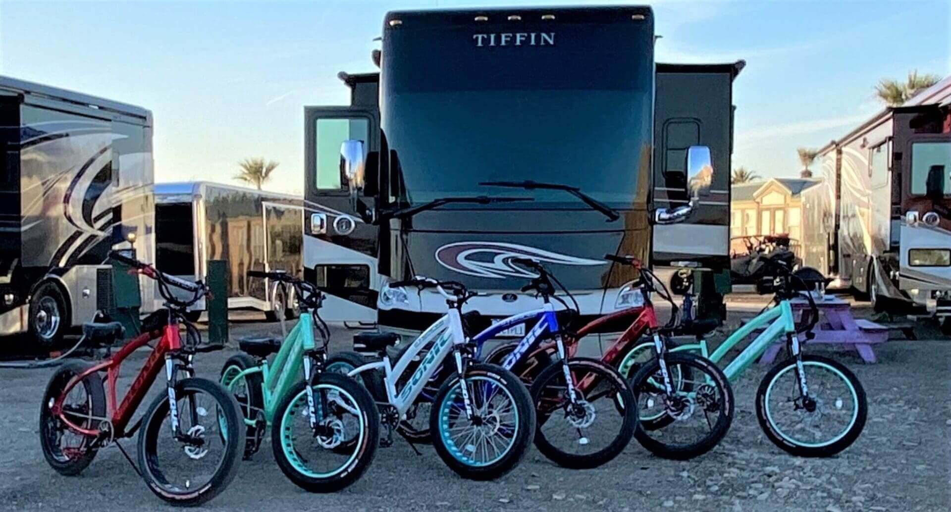 Five bicycles parked in front of RV.
