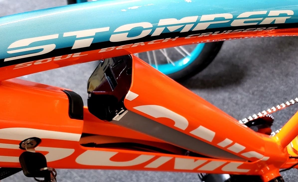 Orange and teal bicycle frame close-up.