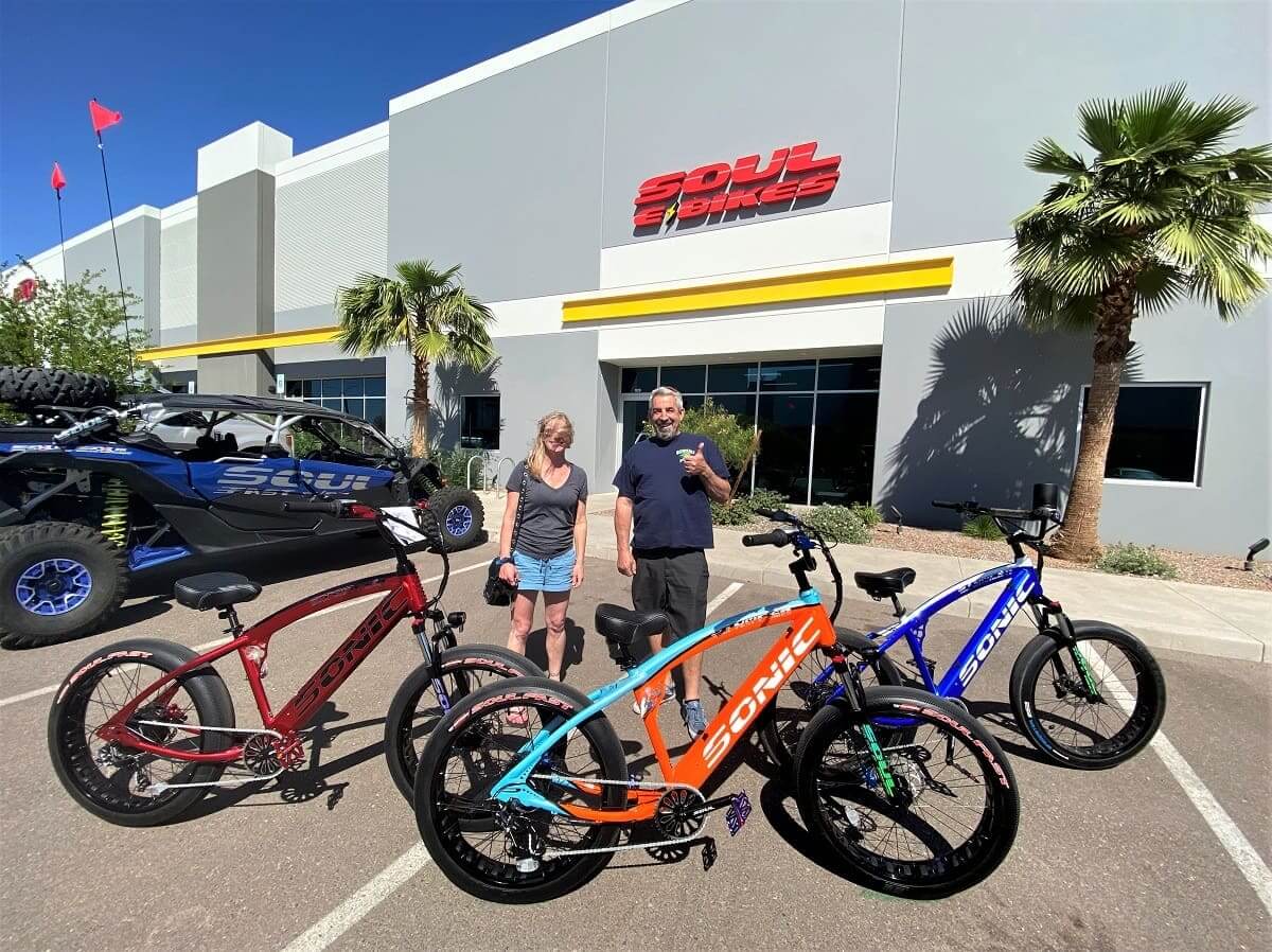 People with colorful bikes outside Soul Bikes building.