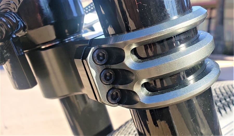 Metallic clamp on a black tubular structure.