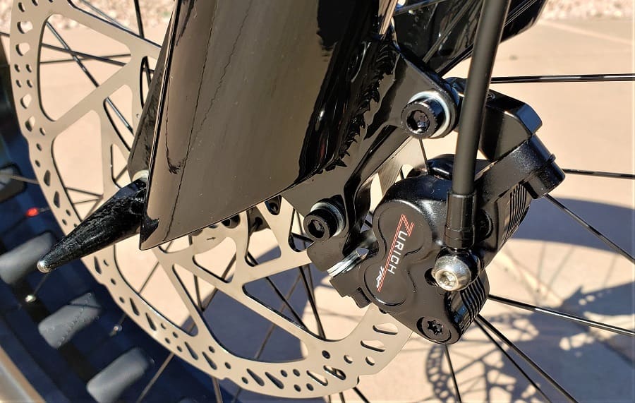 Bicycle disc brake and caliper close-up.