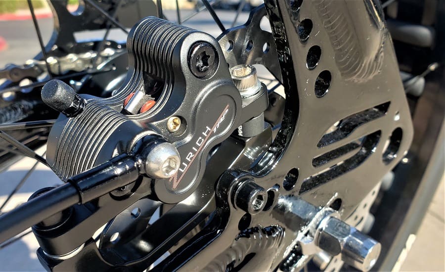 Bicycle disc brake close-up in sunlight.