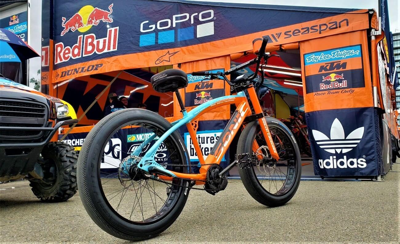 Orange and blue bicycle in racing tent.