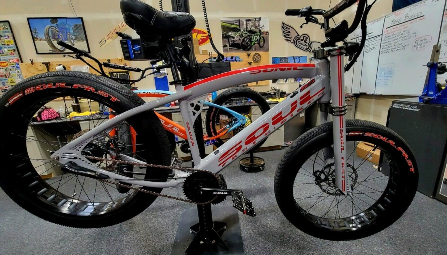 Silver bicycle displayed in a workshop.