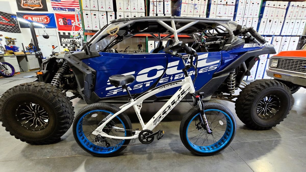 Off-road vehicle and bicycle in garage.