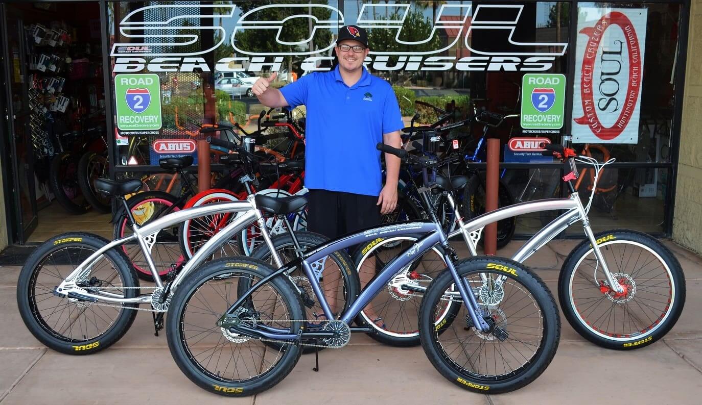 Man standing with bicycles outside Soul shop.