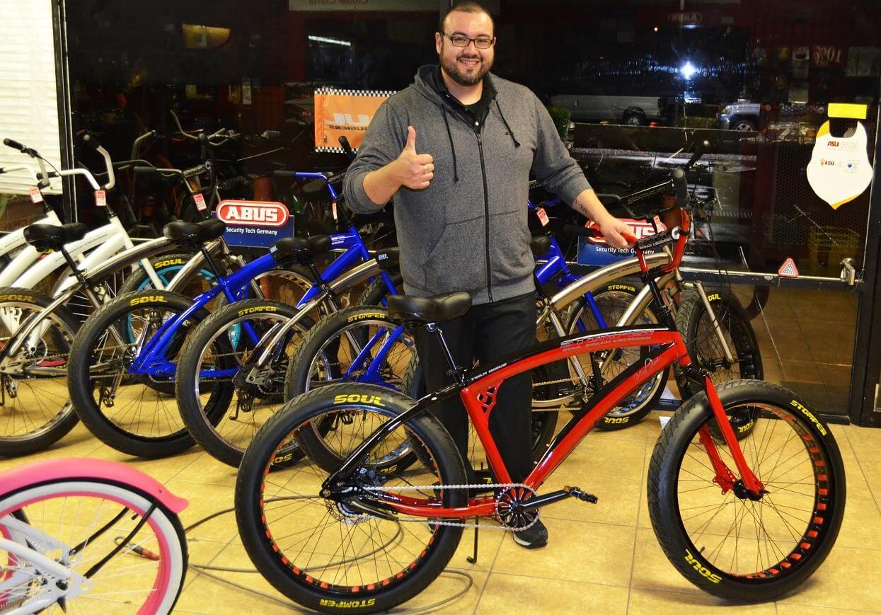 Man giving thumbs up next to bicycle.