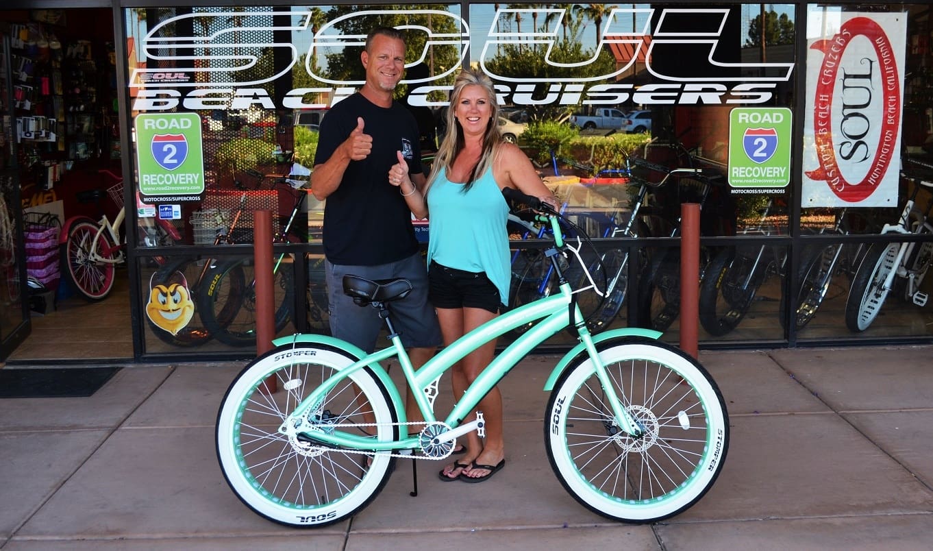 Man and woman with mint green bicycle.