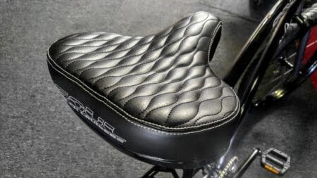 Black leather bicycle seat with quilted design.