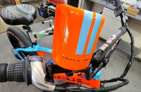 Bicycle with orange and blue handlebar cover.