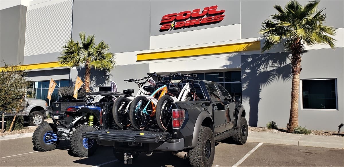 Truck carrying bicycles in parking lot.