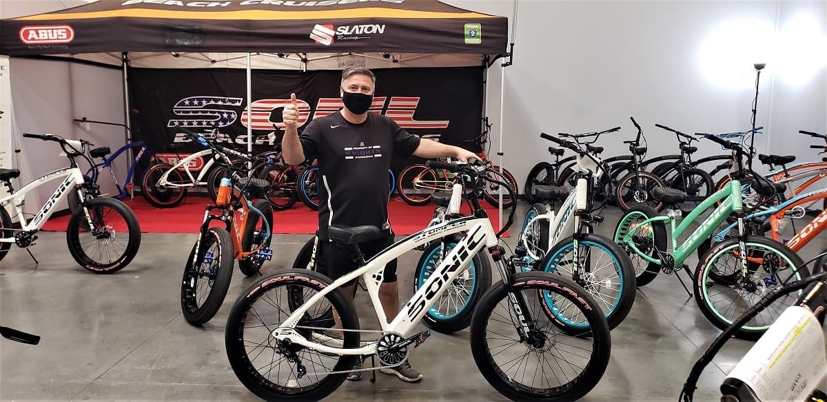Man in bike shop giving thumbs up.