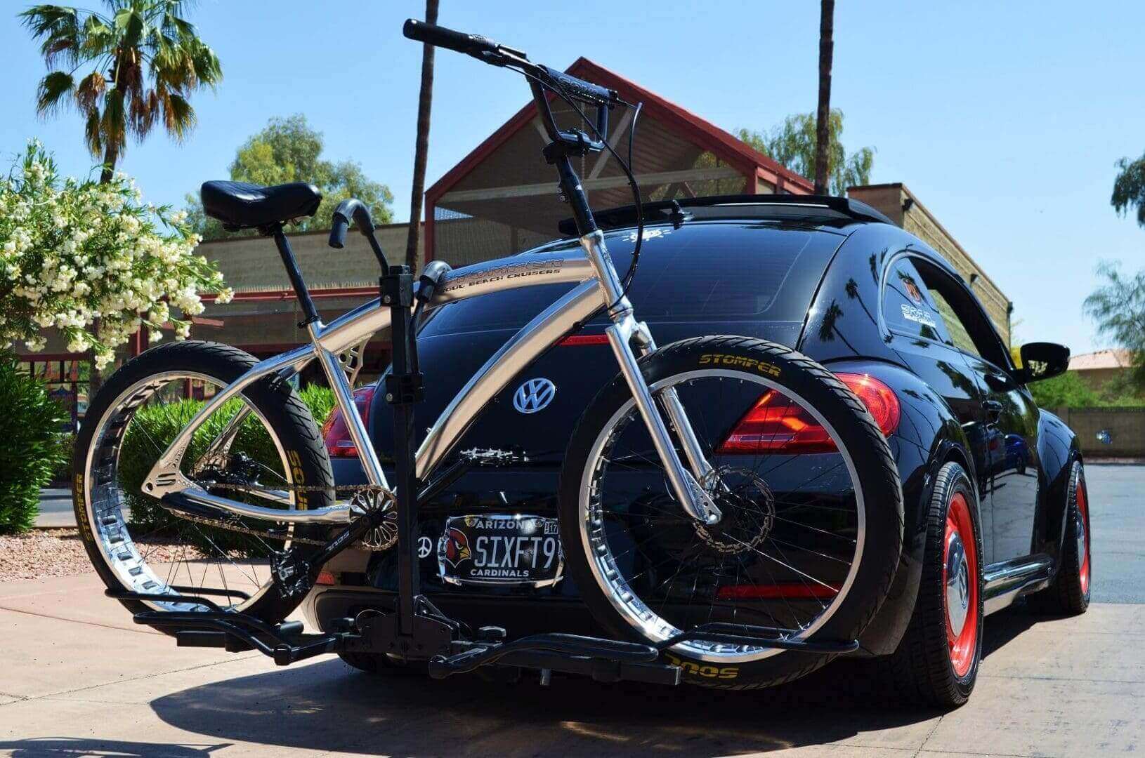 Car with bicycle mounted on rear rack.