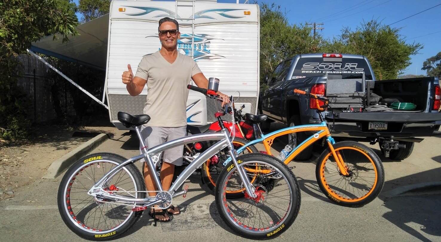 Man with bikes, camper, and pickup truck.