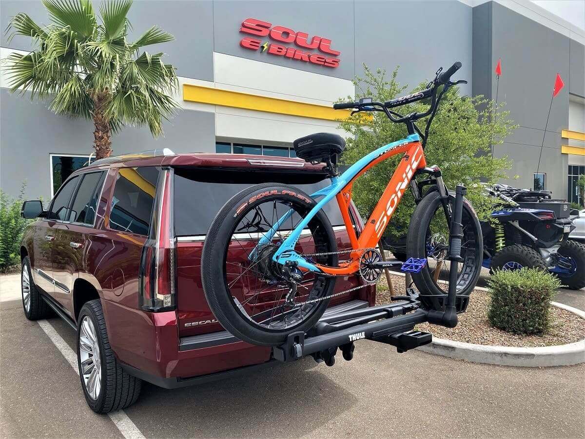 SUV with bike mounted on rear rack.
