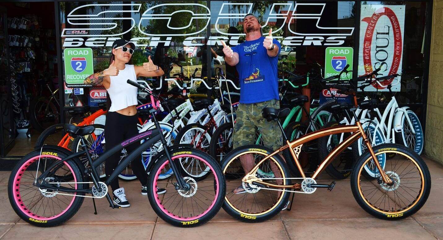 People posing with custom beach cruiser bikes.
