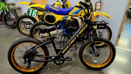 Bicycles and motorcycles displayed in a row.