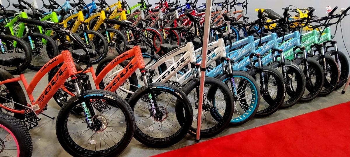 Colorful electric fat tire bikes on display.